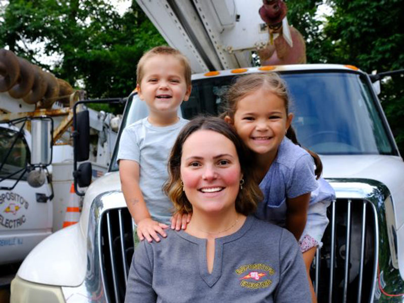 a woman and two children smiling for a photo