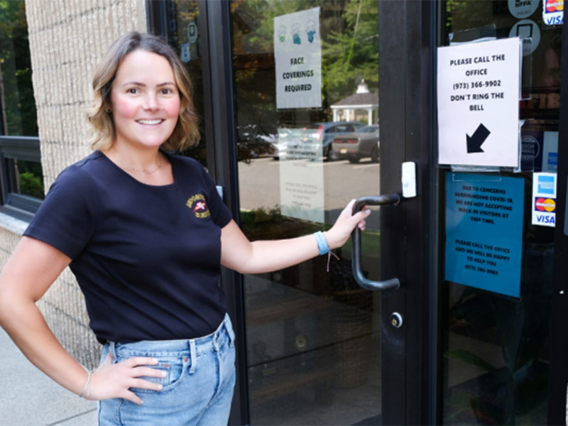 a woman holding door handle